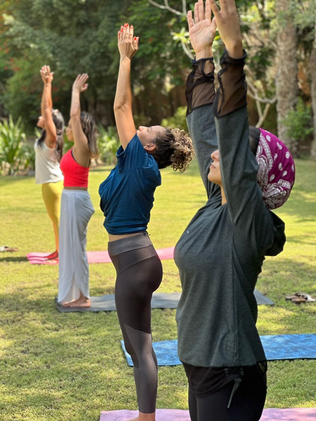 Karim providing individual guidance during a yoga workshop